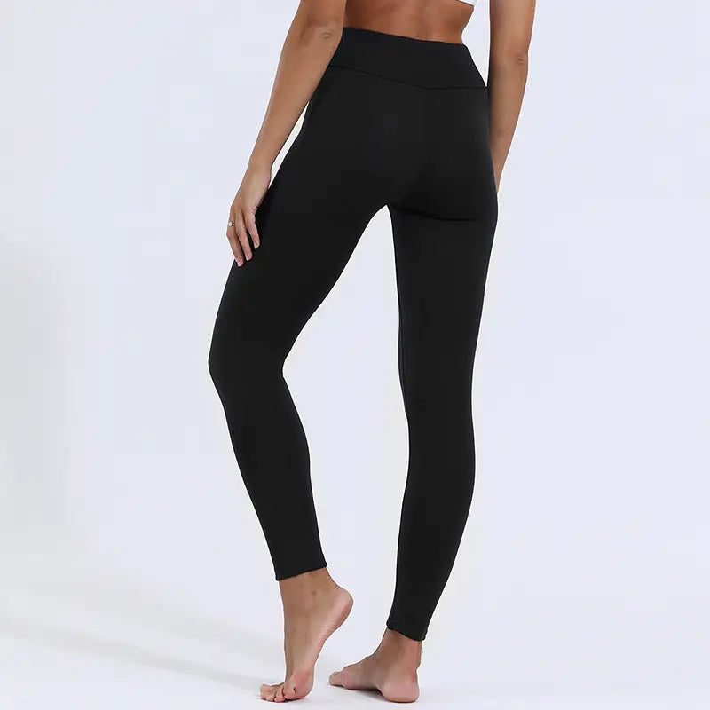 Black high-waisted royale essence lux winter leggings featuring high stretch smooth fabric and a seamless design with fleece lining for warmth.