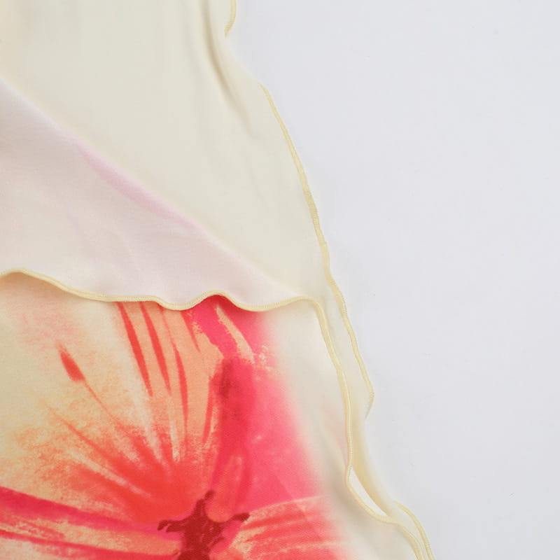 an elegant slim print floral top and skirt set paired with a delicate cream-colored silk scarf featuring a vibrant watercolor-style poppy design in shades of pink and red