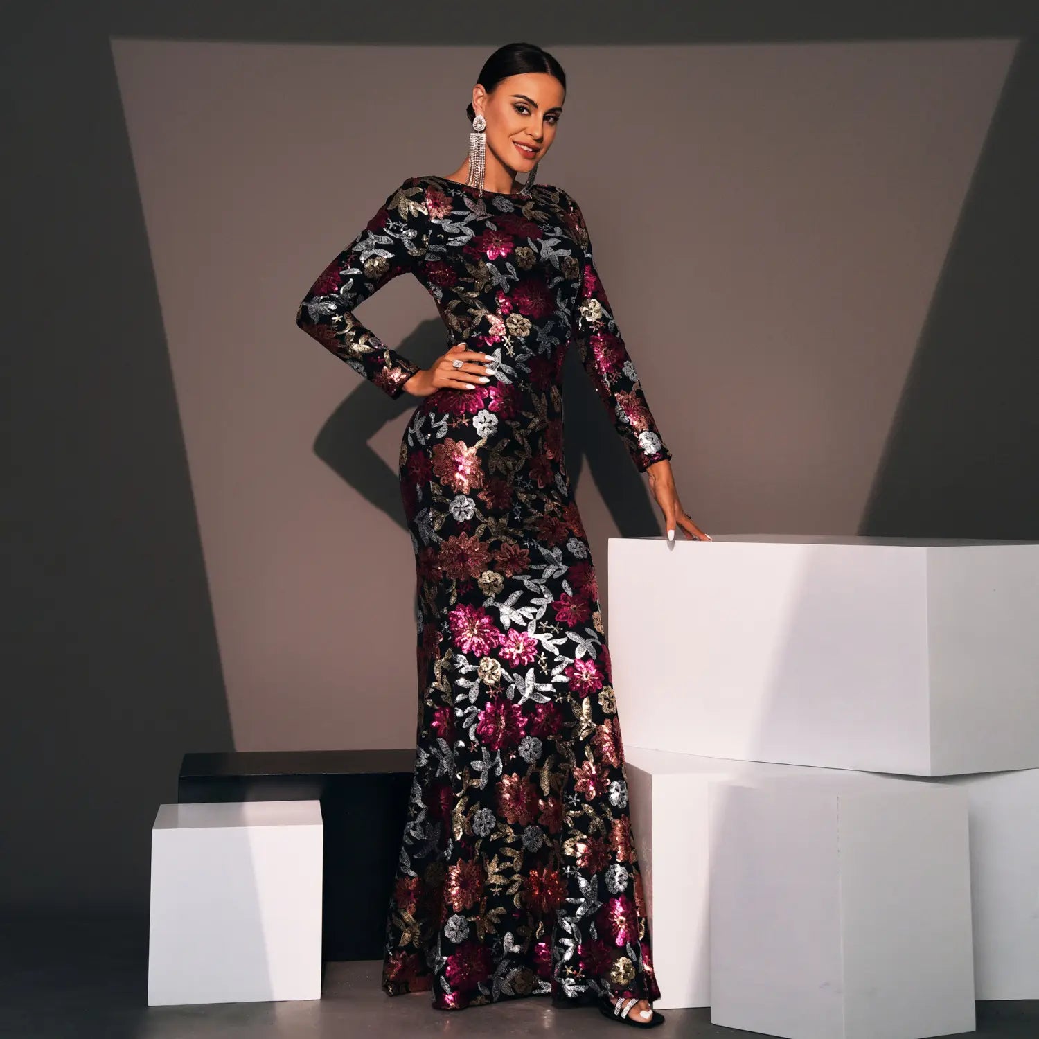 Embroidered floral long sleeve evening gown in black with shimmering magenta and silver patterns featuring a floor-length silhouette.