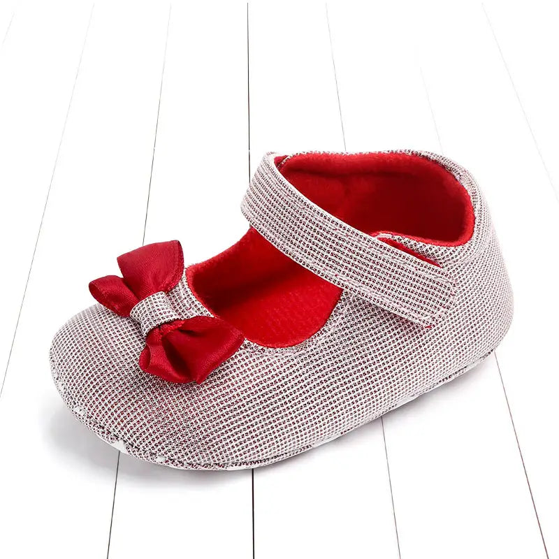 Silver mesh princess shoes bow for babies featuring a red satin bow and plush red interior as shoes bow baby.