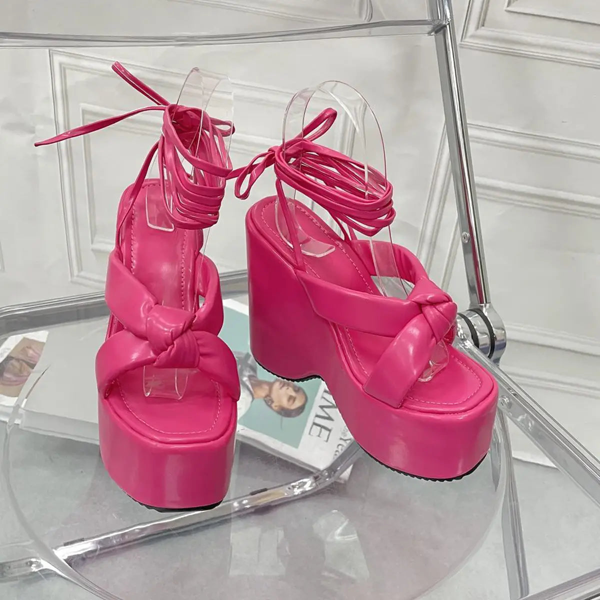 Vibrant pink platform wedge high heel ankle tie sandals with glossy patent leather straps and a thick chunky high heel platform.