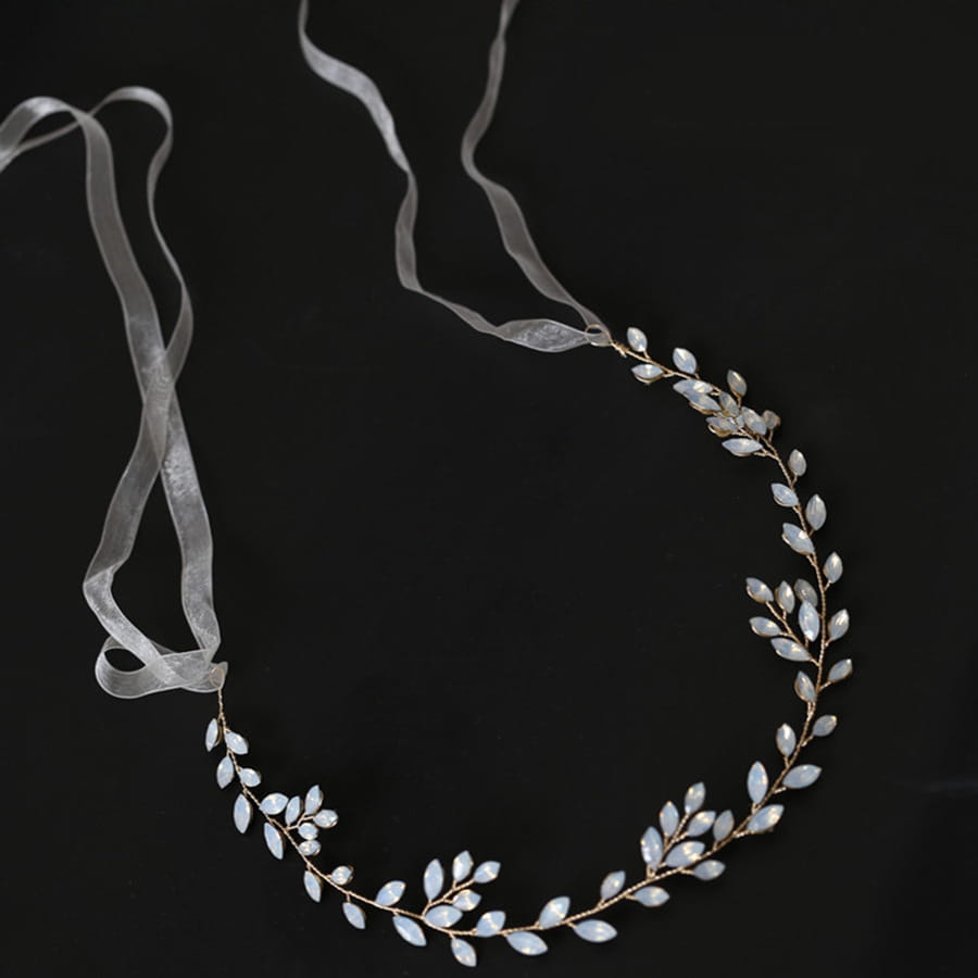 Elegant silver leaf protein rhinestone headdress hair band featuring delicate gold-toned branches, translucent white gemstones, and sheer ribbon ties.