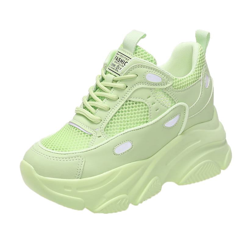 Light green chunky platform casual sports single sneaker with mesh and synthetic overlays featuring white oval cutouts and a padded collar.