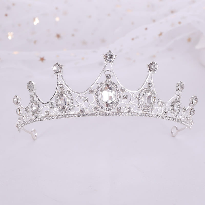 a vintage baroque alloy silver tiara featuring intricate filigree with a central oval crystal and smaller clear stones along its crown-shaped design