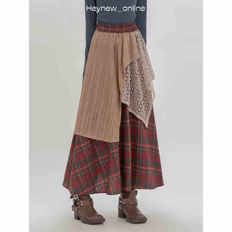 a retro minority irregular plaid a line skirt featuring a layered patchwork design with a red and green plaid lower section, a tan ribbed knit middle layer, and an off-white lace overlay