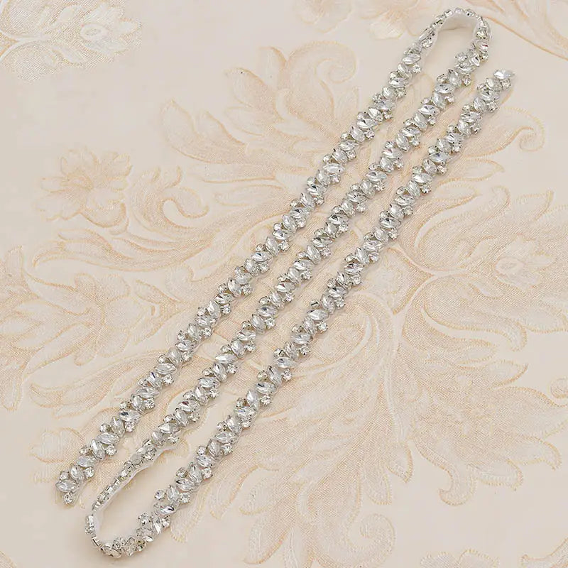 A sparkling silver rhinestone applique wedding sash belt with delicate beaded design for wedding dress waist jewelry.