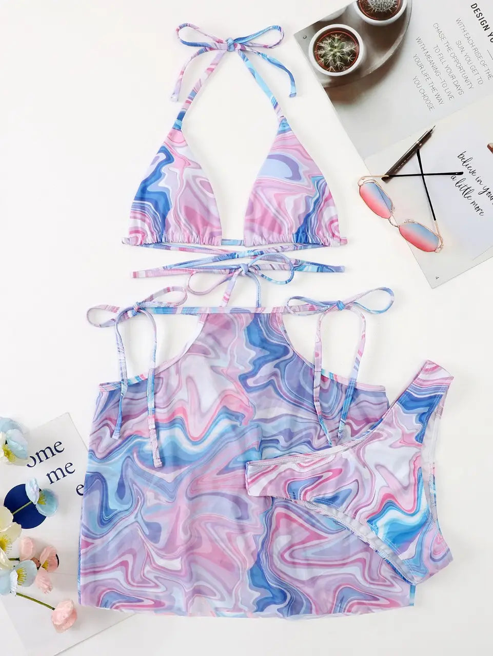 A vibrant pink blue and purple marbled bikini 3-piece beach skirt set featuring adjustable tie straps.