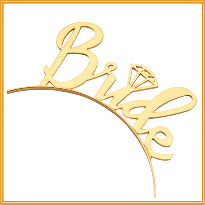 Gold-colored bride cake topper with diamond-shaped embellishment paired with a pink gold foil bride to be bridal veil popular for wedding decoration.