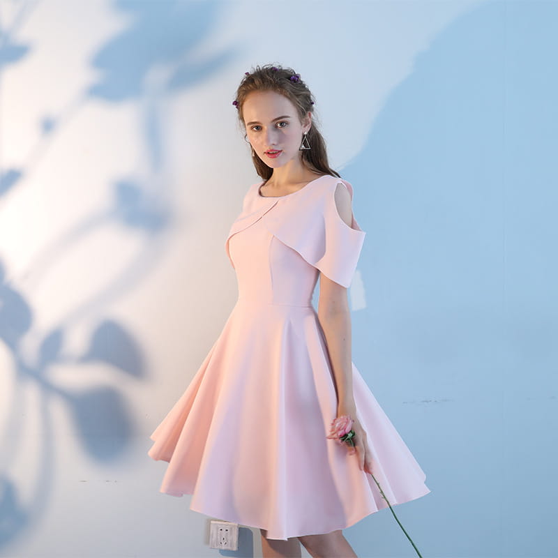 A soft pink short sisters off shoulder ruffled dress featuring a midi length, flared skirt, structured bodice, and main fabric composition ideal for elegant occasions.