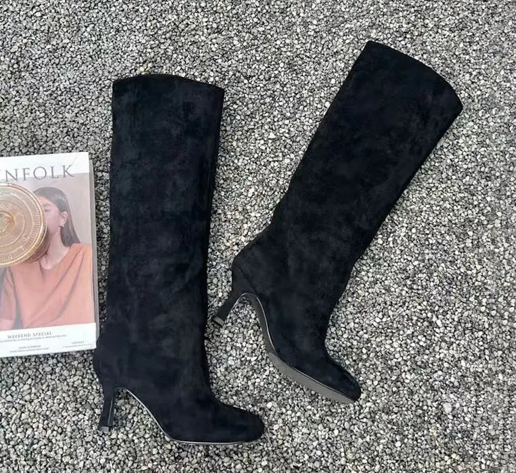 simple stitching square head black knee high boots made of black suede with a sleek pointed toe and slender heel designed for a yards custom fit