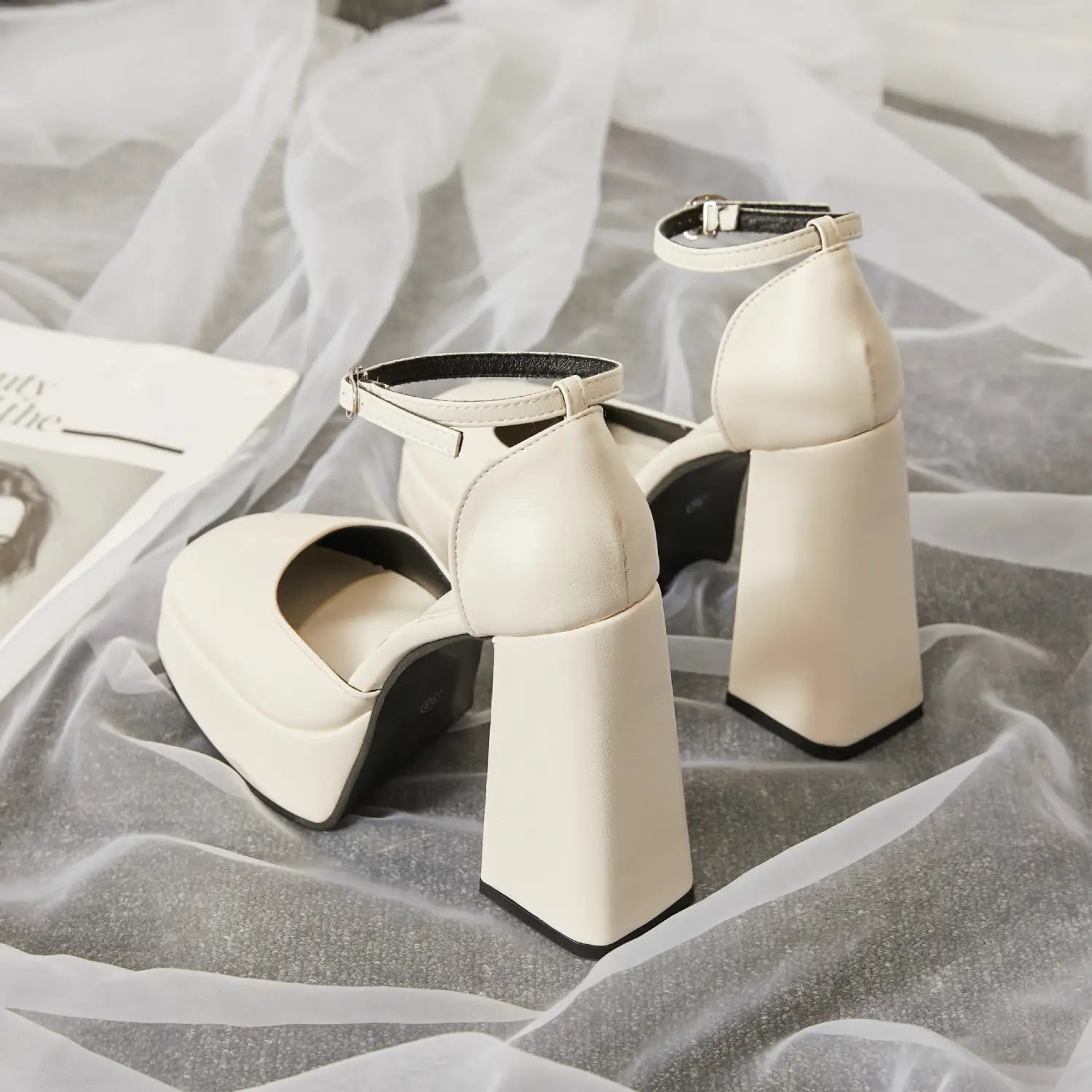 cream-colored patent white super high heel platform mary janes with a chunky block heel and ankle strap