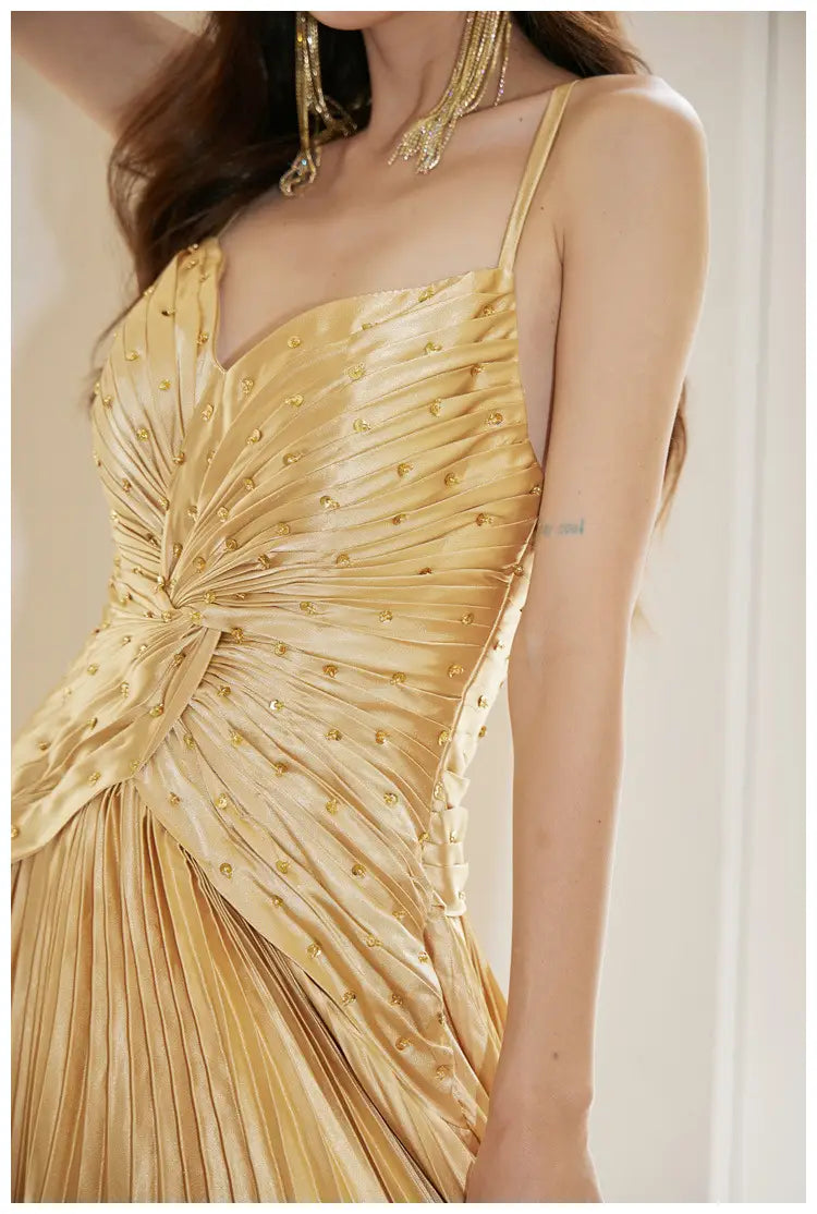 A shimmering gold satin heavy industry birthday dress featuring a ruched bodice, delicate pleats, and subtle golden embellishments.