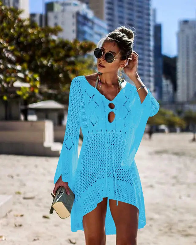 A vibrant turquoise long-sleeved crochet cover-up dress with a v-neck and keyhole cutouts designed for bikini women swimsuit use.