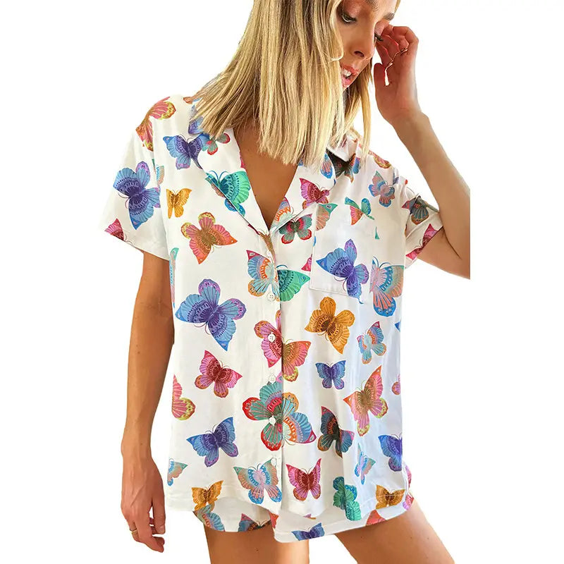 white short sleeve homewear suit with vibrant butterfly print short in shades of blue purple pink and green