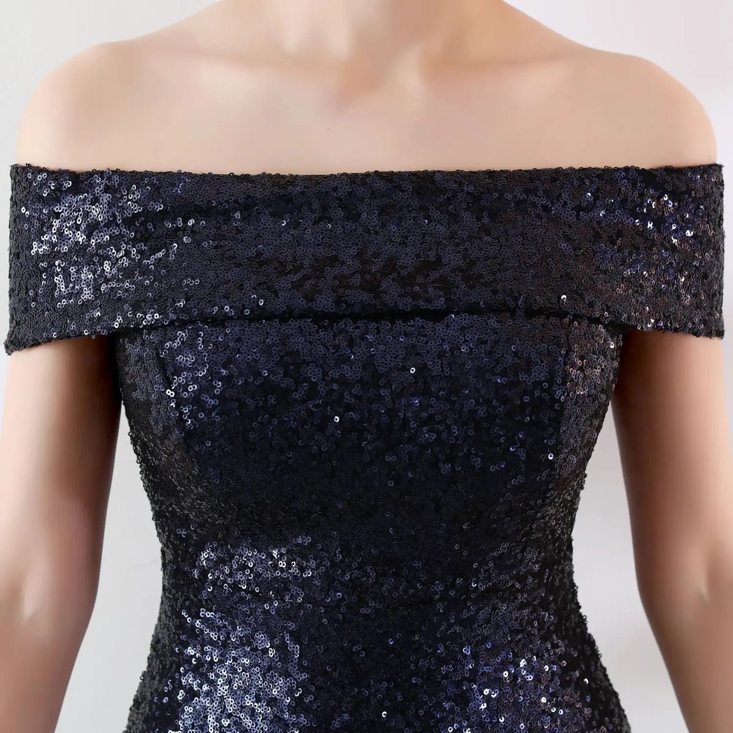 A shimmering black sequined off-the-shoulder birthday party dress with a fitted silhouette designed for a slimming host gown.