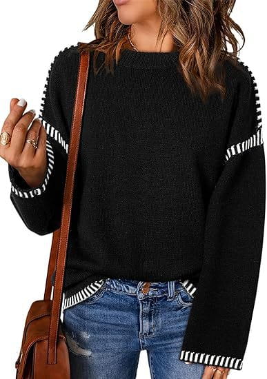 Black solid round neck pullover knit sweater featuring contrasting white and black striped accents on the sleeves.