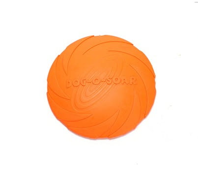 Orange dog-o-soar frisbee with a textured ridged surface and embossed branding designed as a bright colorful dog training rubber toy for pet dog training.