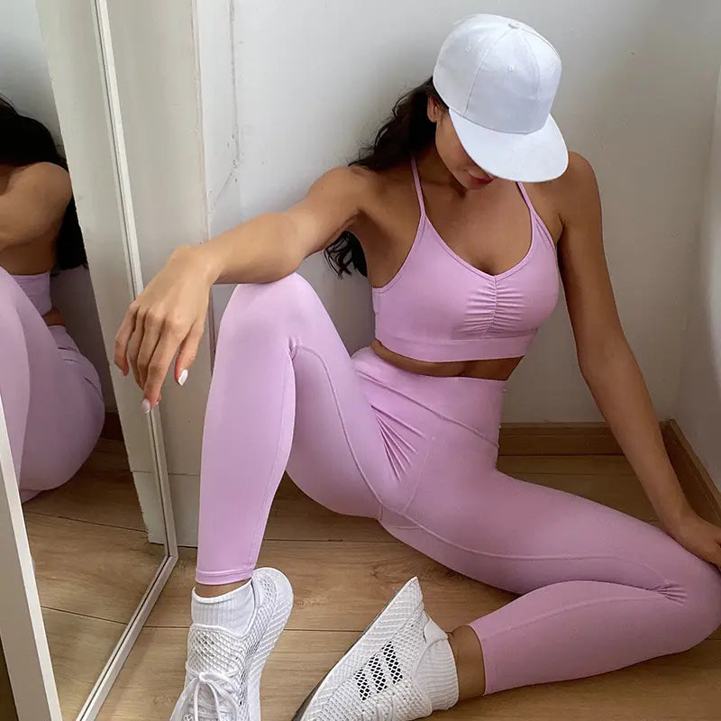 A soft lavender nude sensation waist gathering two piece yoga set featuring a ruched sports bra and high-waisted leggings made from stretchy, form-fitting material by ck+wx.