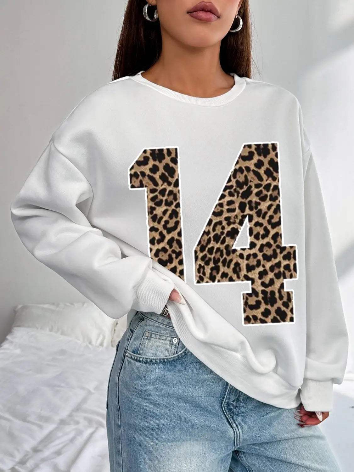 White crew neck sweatshirt featuring a bold black leopard-print number 14 across the front.