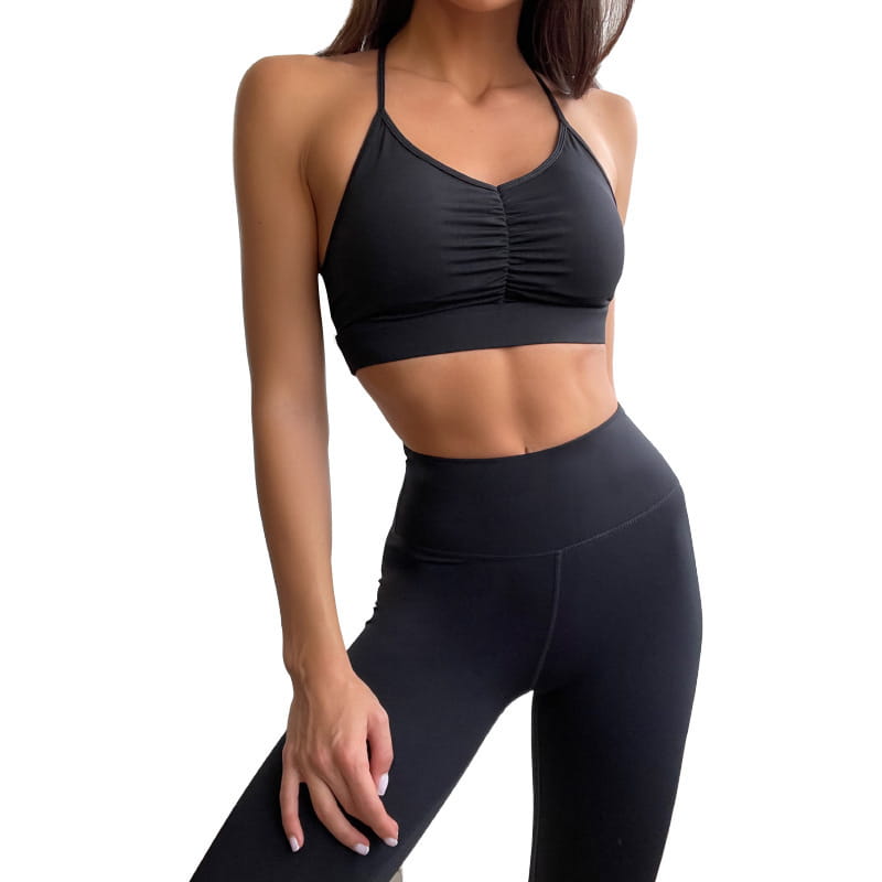black ruched halter-style sports bra with high-waisted matching leggings from the nude sensation waist gathering two piece yoga set by ck+wx