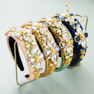 A collection of ornate baroque vintage court style crystal headbands in pastel and deep hues featuring intricate floral designs made from sparkling crystals.