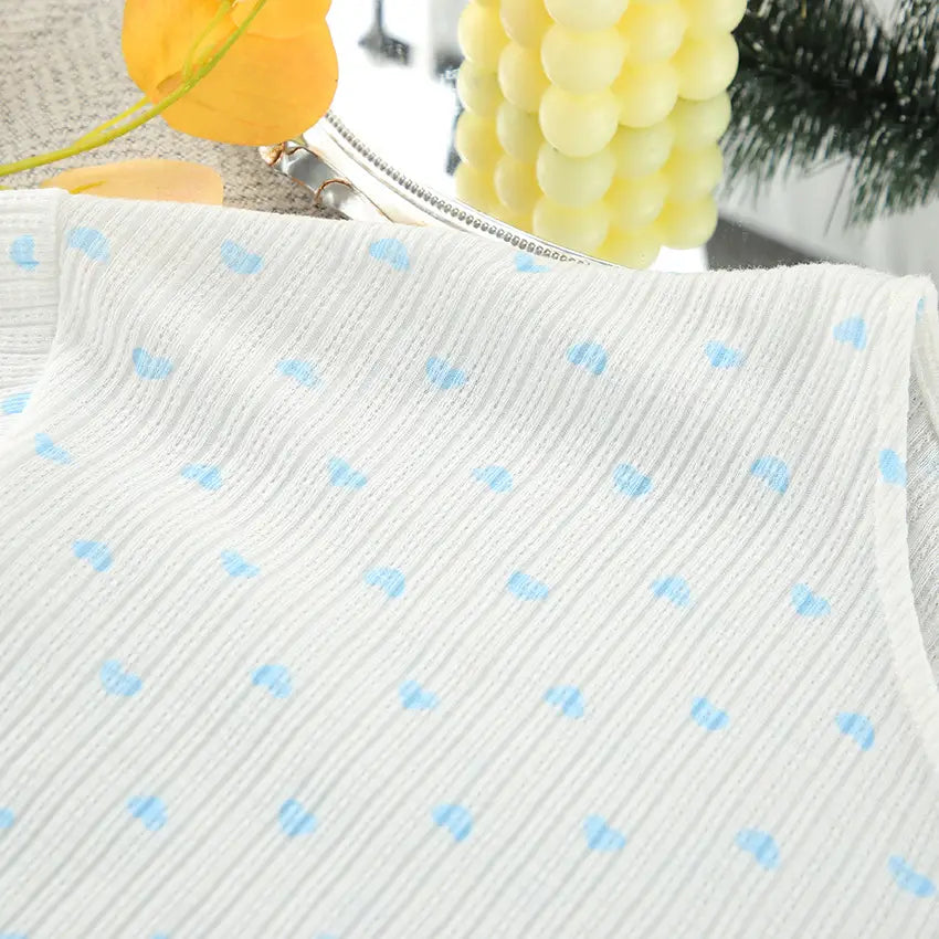 White ribbed fabric top featuring light blue knitted heart printing in a comfortable loungewear set.