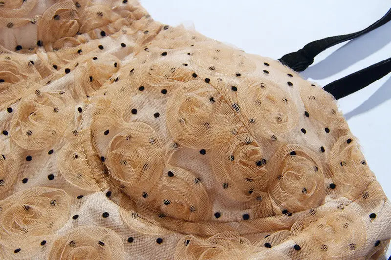 a delicate beige lace bra with black polka dots and three-dimensional rose appliqués paired with a blush pink lace slim drawstring dress.