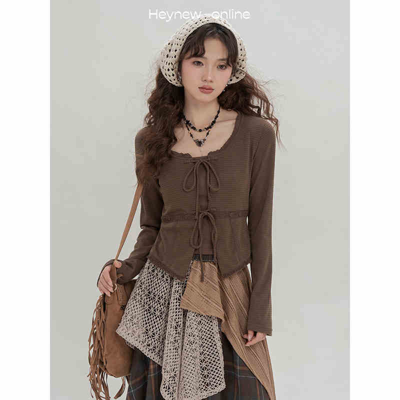 brown ribbed knit long-sleeved top with lace-up front and square neckline paired with retro minority irregular plaid a line skirt.