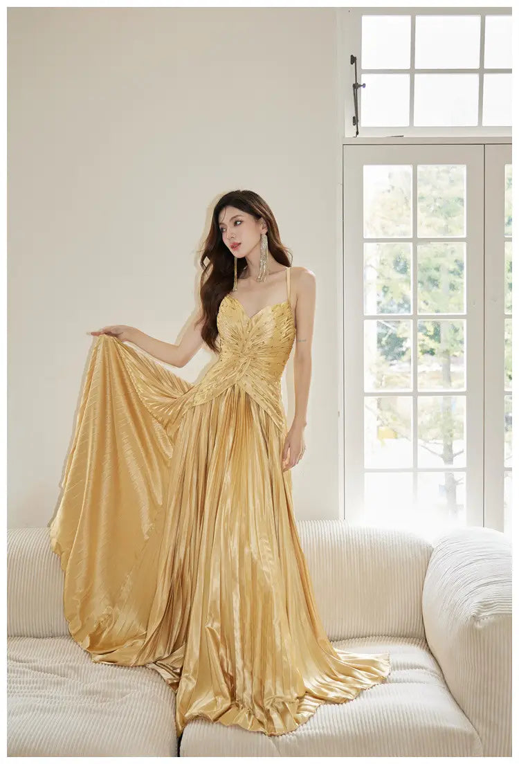 A shimmering gold satin heavy industry birthday dress with a fitted bodice and flowing skirt.