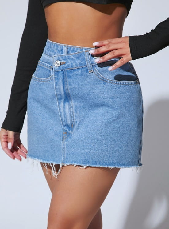 A high waisted fashion irregular denim short skirt in medium blue wash with frayed hem and classic front button closure.