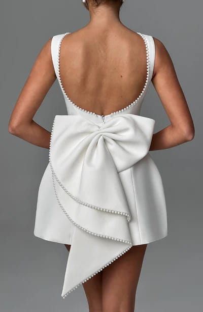 white satin backless dress summer slim featuring a dramatic back bow and pearl-trimmed straps for an elegant summer look
