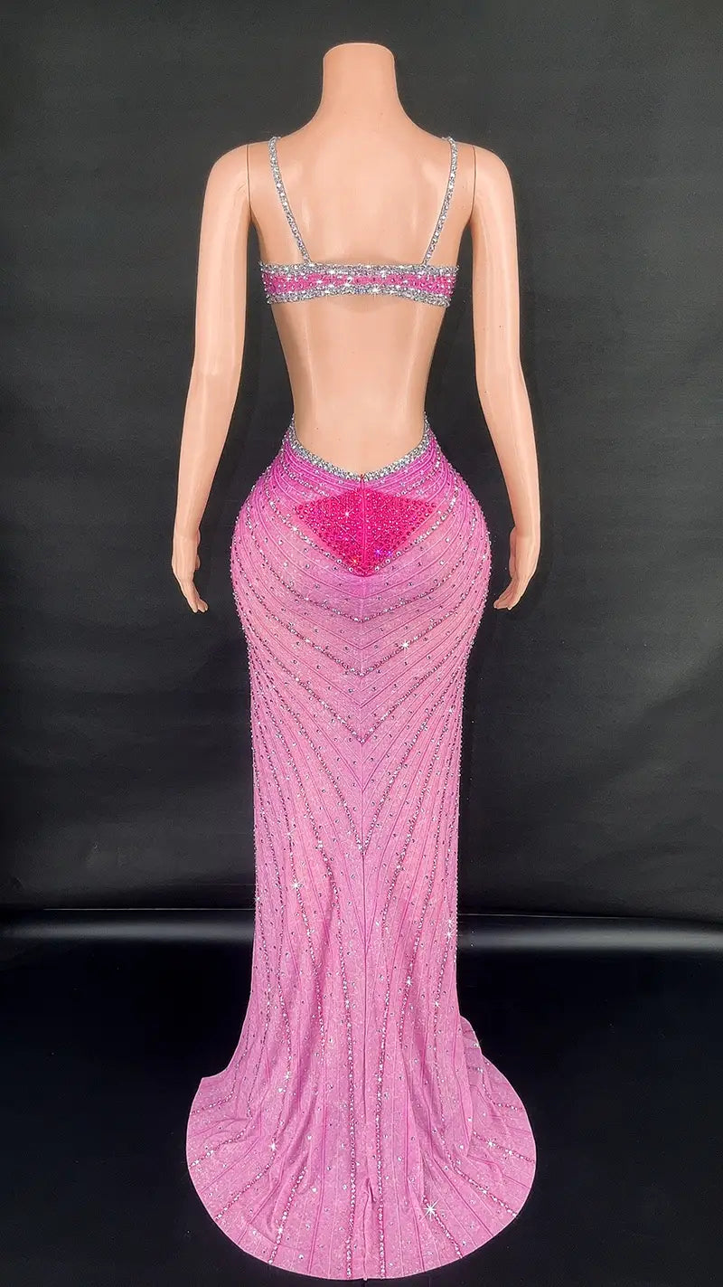 a shimmering pink sling super shiny mermaid-style evening gown with intricate silver beading and a bold geometric design on the back