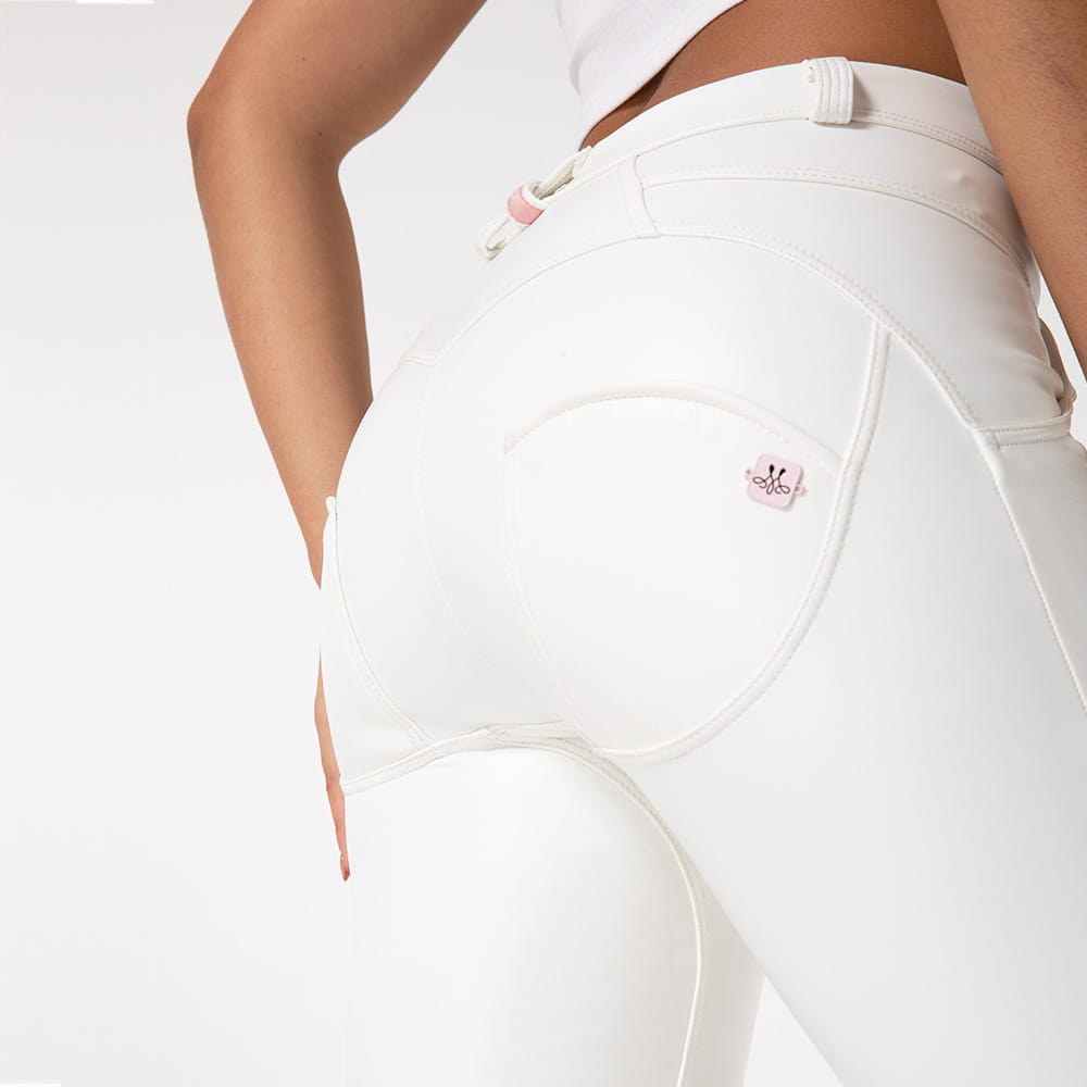 white pu leather high waisted skinny pants shown from the back side featuring white glossy leather fitness pants with subtle pink royale essence lux branding on the back pocket.