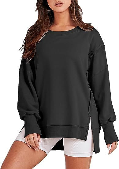 black solid oversized sweatshirt with side slits and ribbed cuffs featuring a crew neck design