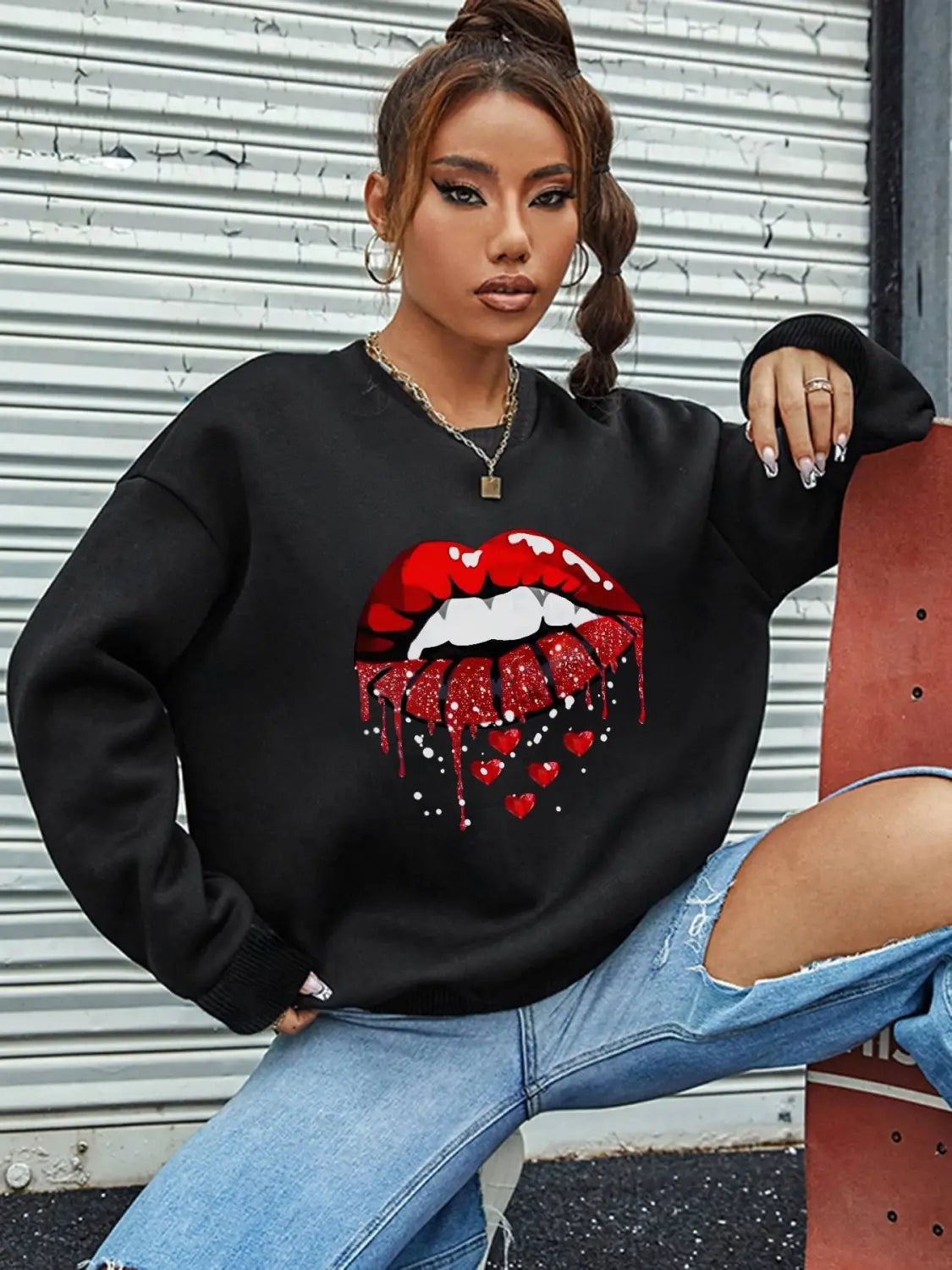 black pocketed long sleeve sweatshirt featuring a bold red glittery lips graphic dripping with hearts and sparkles