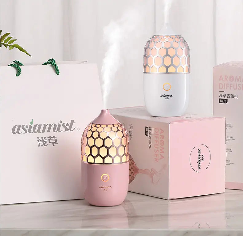 Asakusa pink aroma diffuser features a pink and white honeycomb-patterned design emitting a gentle mist for aromatherapy.