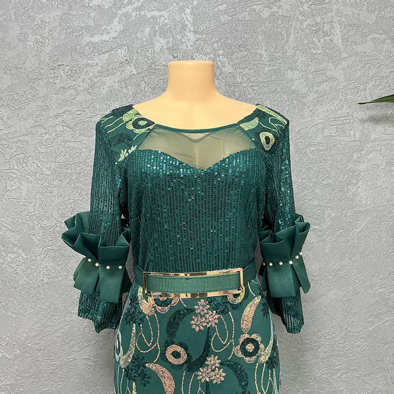 Emerald green sequined round neck slim fit half sleeve evening dress with ruffled sleeves and a gold-toned belt.