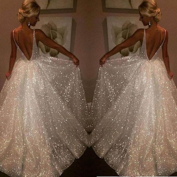 Pure white sequined wedding evening dress with a deep v-back and delicate spaghetti straps shown from the back.