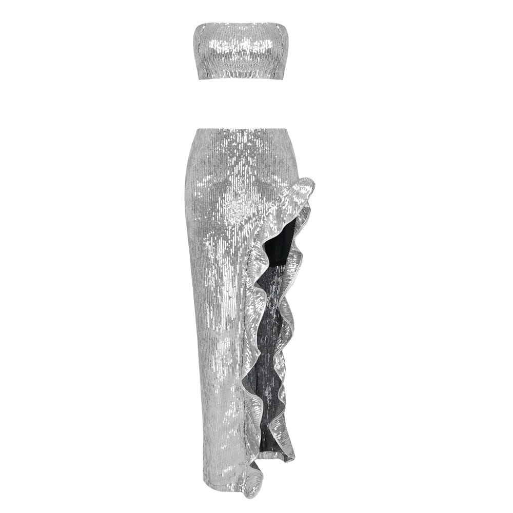 Silver strapless sequin skirt set featuring a shiny silver sequined two-piece design with a strapless top and high-waisted skirt with ruffled side slit.