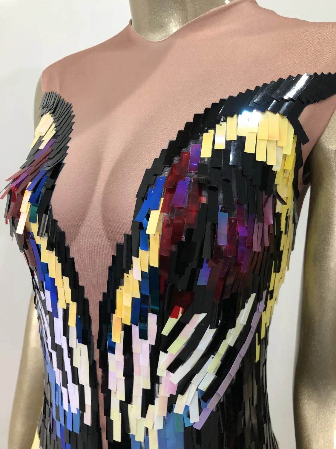 A sequin evening dress female featuring a vibrant bodice with a bold geometric pattern in black yellow blue red and purple designed for dress female singer use.