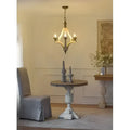 Antique-style brass light wood chandelier with distressed white finish and three candle-shaped bulbs for dining hall entrance