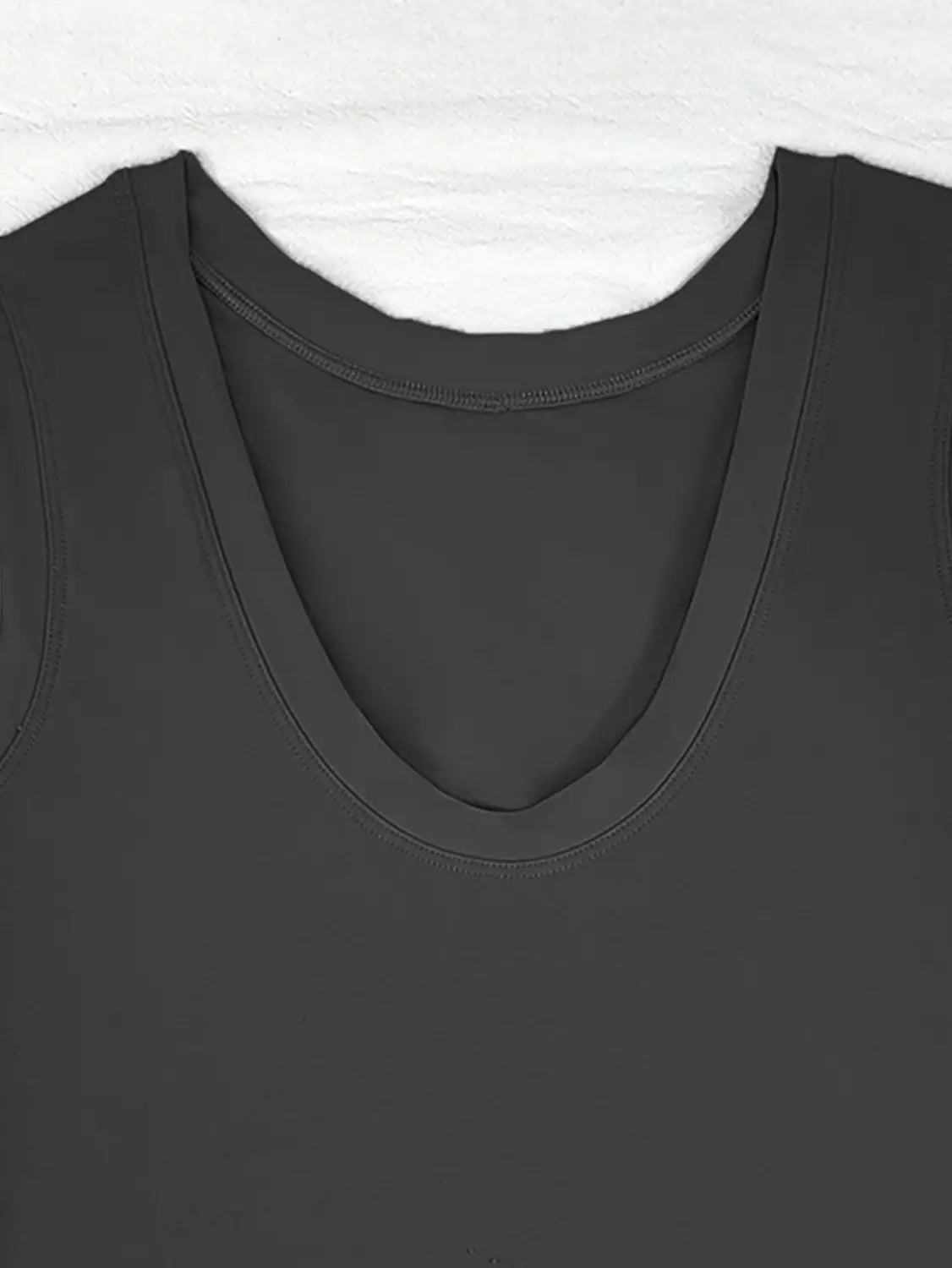 black sleeveless top with soft stretchy fabric and gently curved neckline paired with a sleeveless side slit yoga tennis skirt sport dress