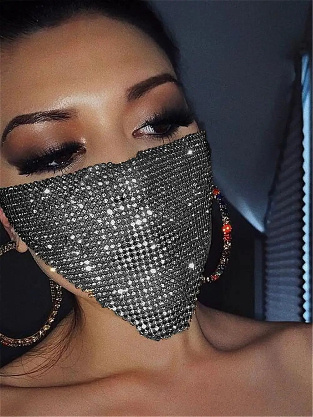 a sparkling silver rhinestone face mask with a dense grid of glittering crystals and colorful beaded ear loops showcasing explosive metal flash in a metal flash jewelry mask design