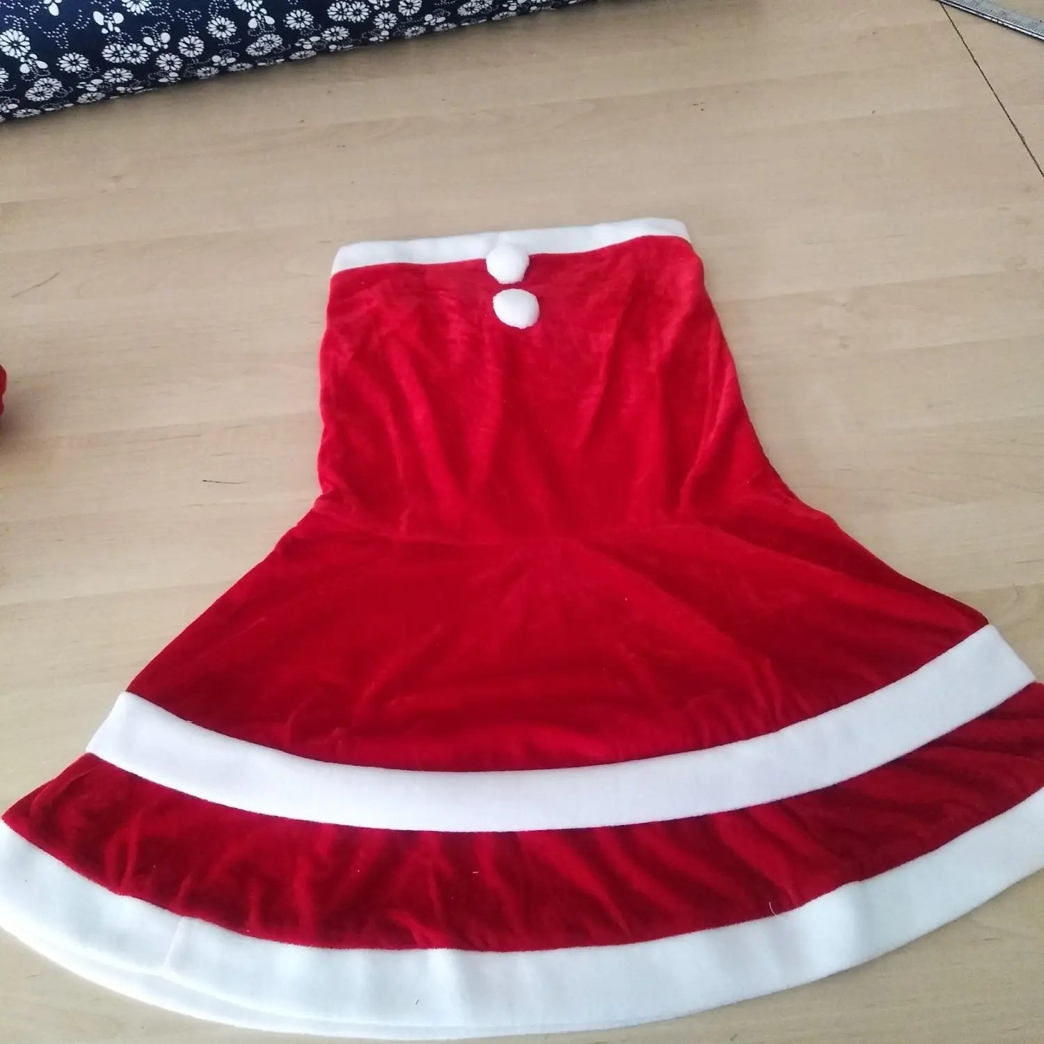 adult female costumes christmas velvet santa dress featuring a red velvet skirt with white trim and two fluffy white buttons at the waist designed for festive occasions