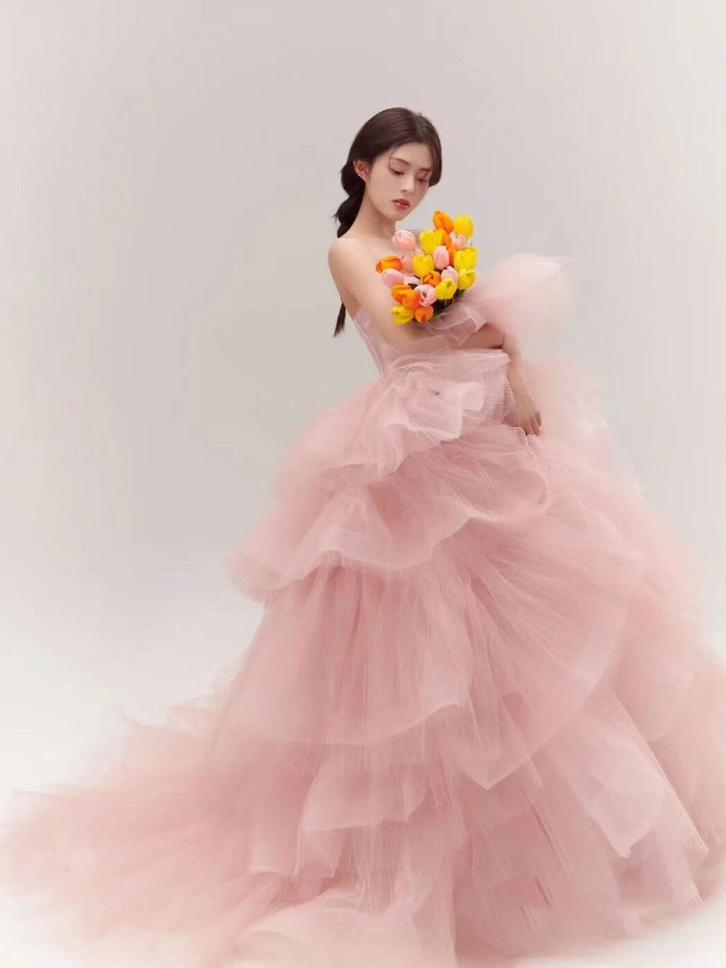 a flowing multi-tiered pink tulle gown with a strapless bodice and voluminous skirt showcasing dress fairy temperament and temperament main yarn features