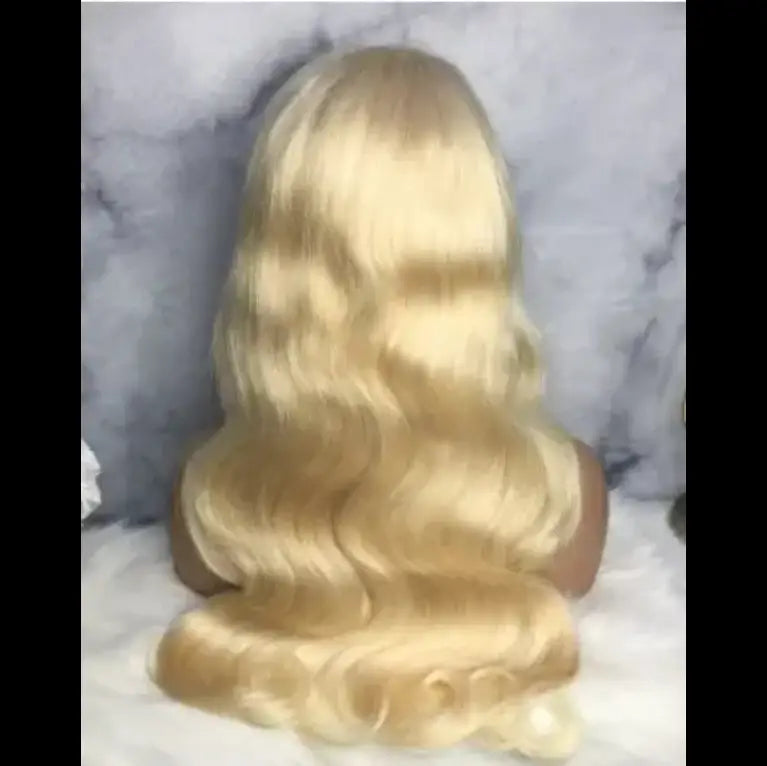 30 inch hd 13x4 human hair wig in blonde features voluminous wavy texture with soft highlights and a natural-looking finish.