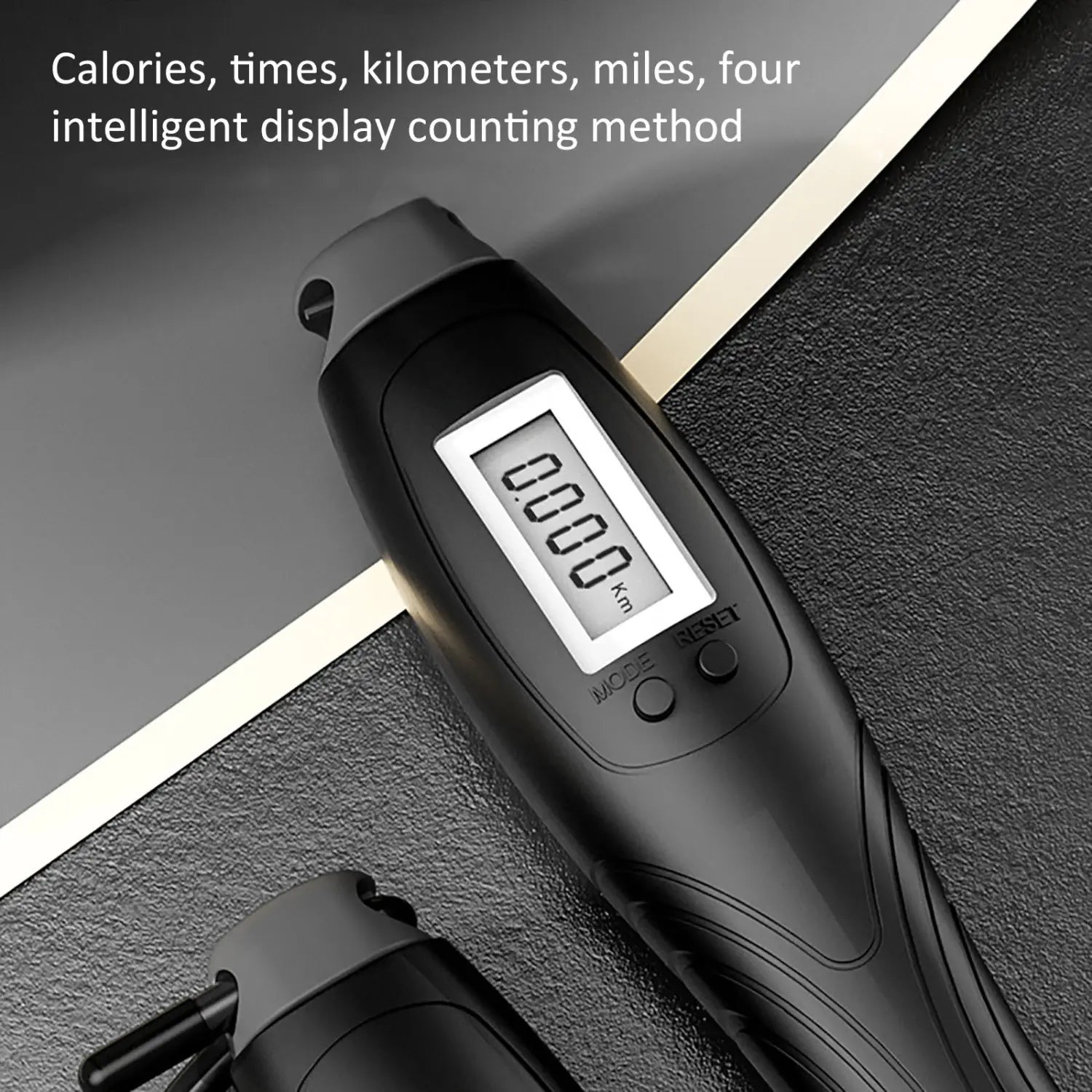 Black cordless electronic skipping rope featuring a black digital fitness tracker with a sleek ergonomic design and an LCD screen displaying 0.000 km for tracking calories times kilometers or miles.