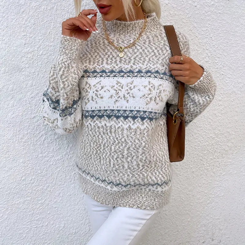 A cozy long-sleeved knit winter snowflake sweater in soft cream and gray with intricate geometric patterns and a half turtleneck design showcasing sweater fashion half turtleneck style.