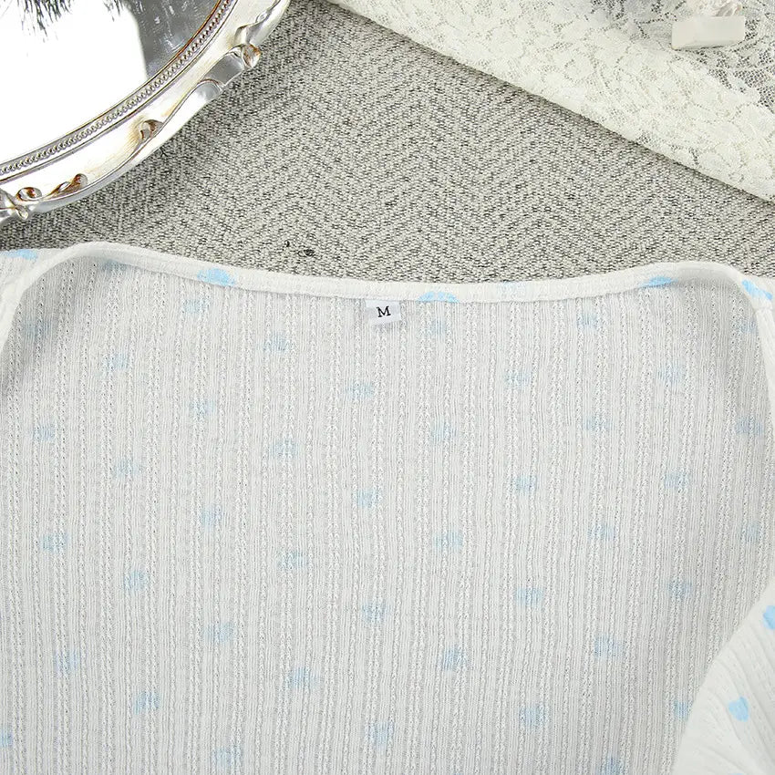A light blue and white striped knitted heart printing ribbed loungewear set top featuring a subtle polka dot pattern in a comfortable knit fabric.