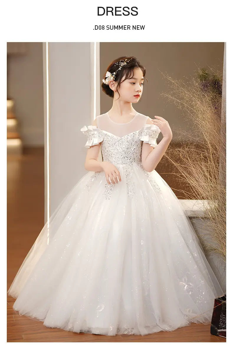 A white off-the-shoulder spandex princess dress for girls featuring delicate ruffled sleeves and sparkling embellishments with a tulle tutu skirt.
